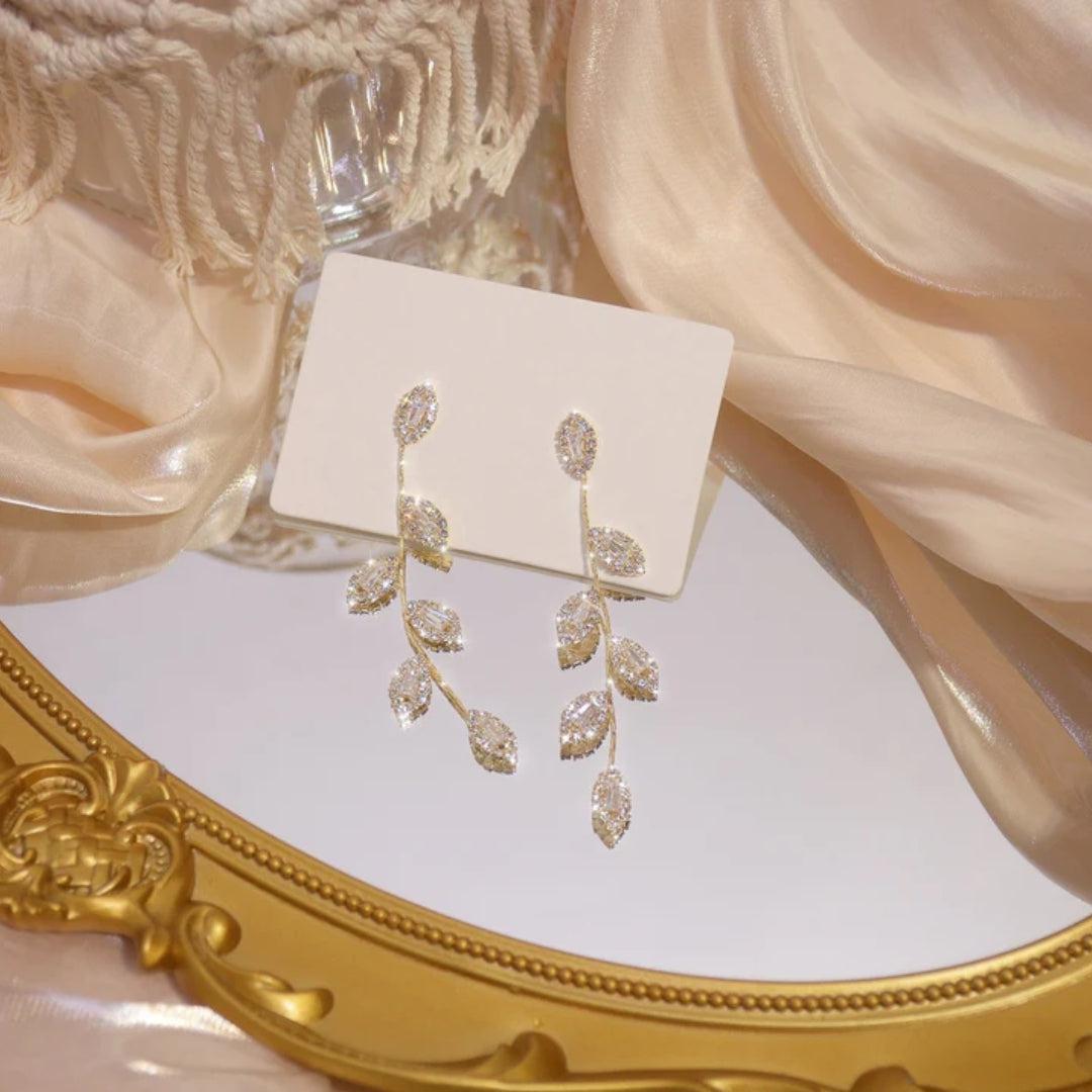 Pilar | Zirconia leaf dangle earrings in gold and silver