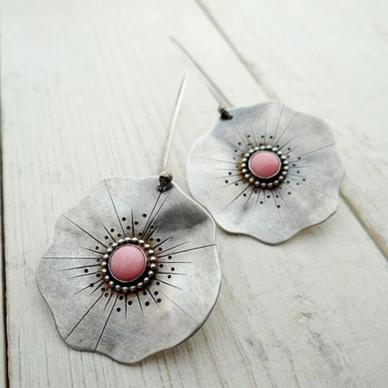 Xiomara | Vintage earrings with silver flower petals and red stone.
